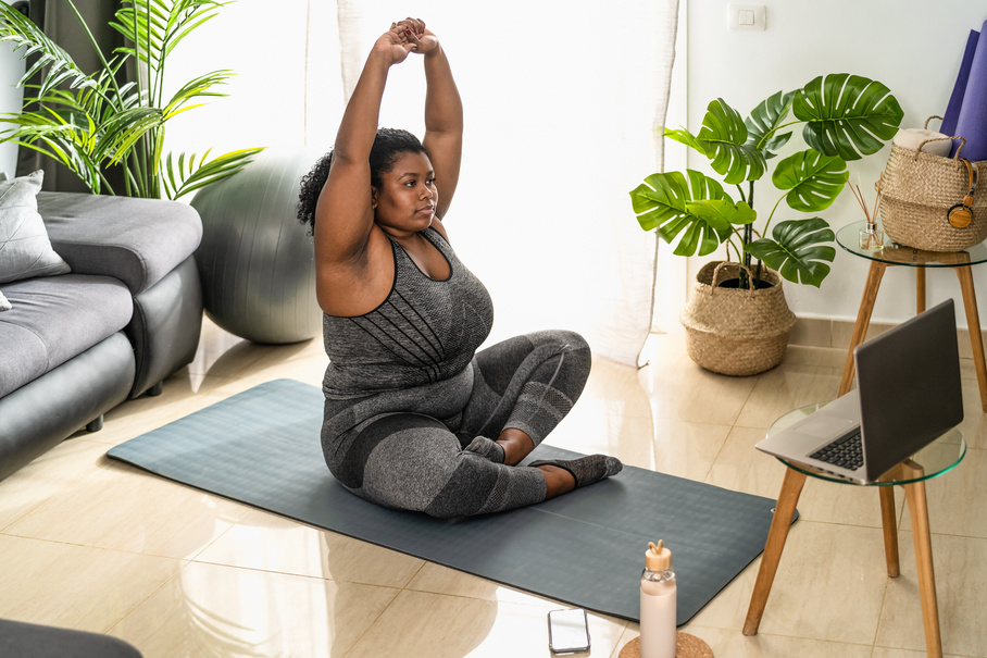 Woman Doing Pilates Online Fitness Class at Home